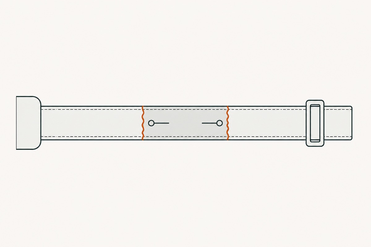 The two halves slid together into a double-thickness overlap, two pins lying across it and its ragged ends marked