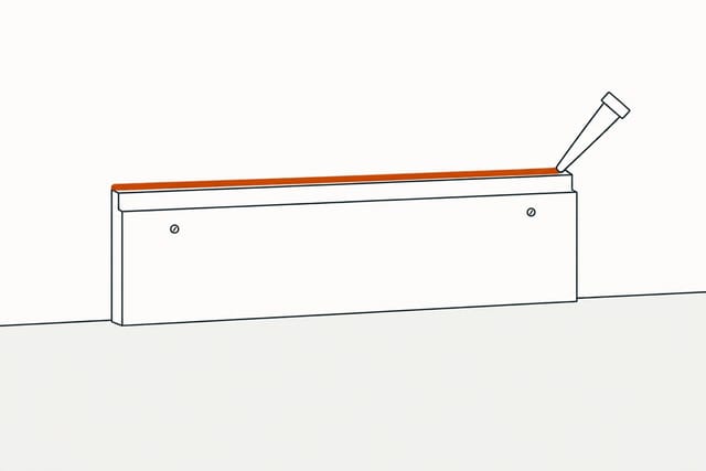 A nozzle running a thin bead along the line where the trim's top edge meets the wall